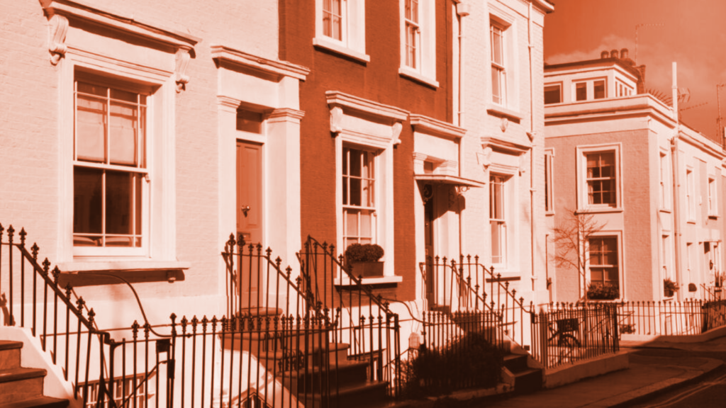 Georgian style terraced houses with white facades, sash windows, and black wrought iron railings in a UK residential street. Hallett Financial Solutions